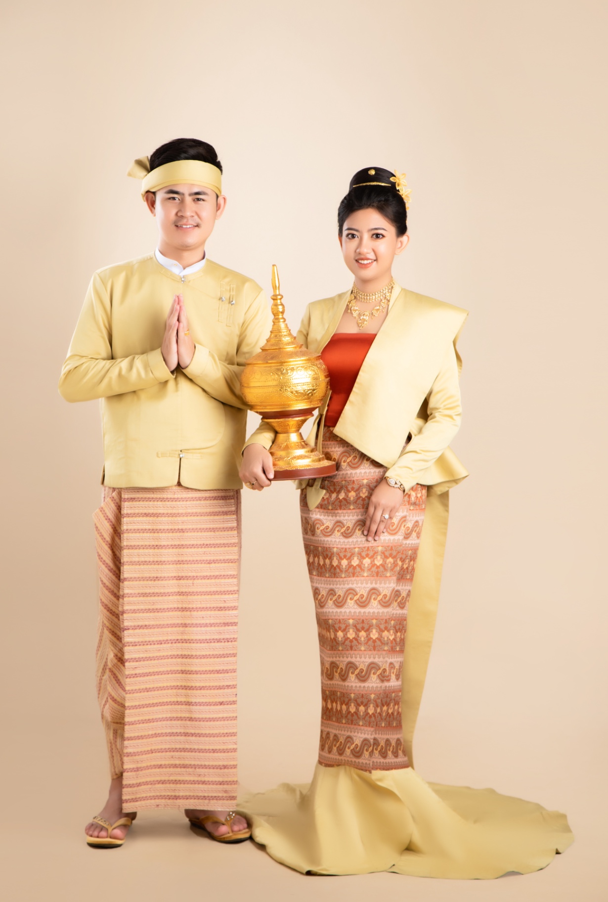 Traditional Myanmar couple standing with ceremonial greeting
